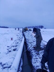 A person standing on top of a snow covered field.