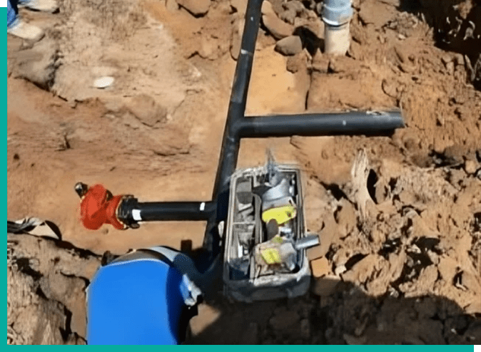 A blue fire hydrant sitting on top of a dirt field.