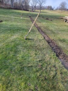 A dirt path in the middle of a field.