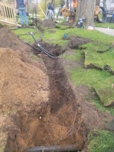 A hole in the ground with grass and dirt