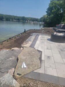 A large concrete slab that has been laid on the side of a lake.