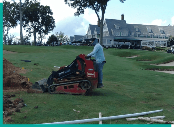 A man is using an atv to remove grass.