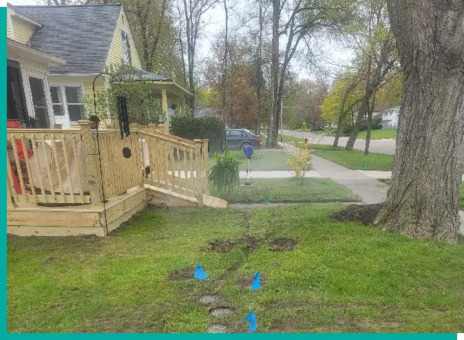 A yard with some blue markers on the ground